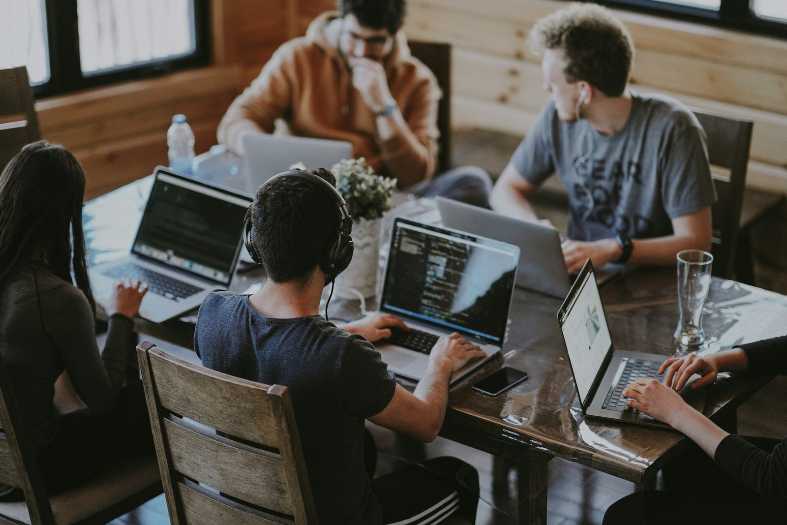 Group of colleagues using laptops together representing business technology