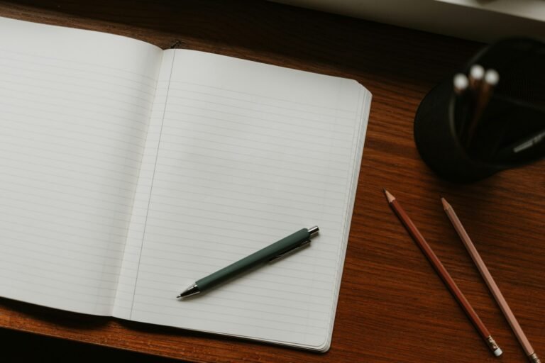 Open notebook and pen on a desk representing productivity and planning