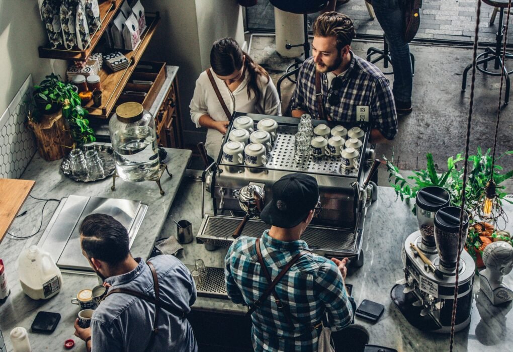 Small business owner at the counter serving a customer