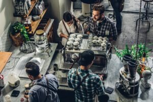 Small business owner at the counter serving a customer