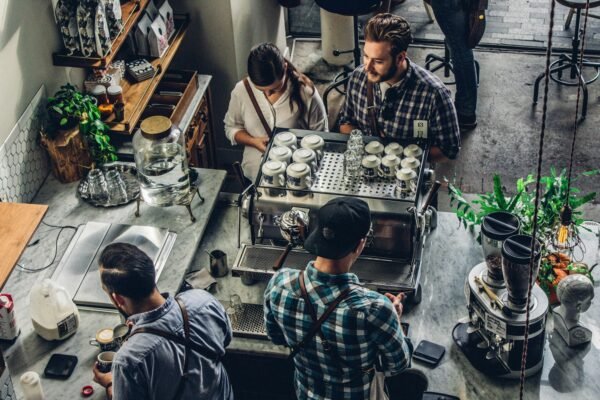 Small business owner at the counter serving a customer