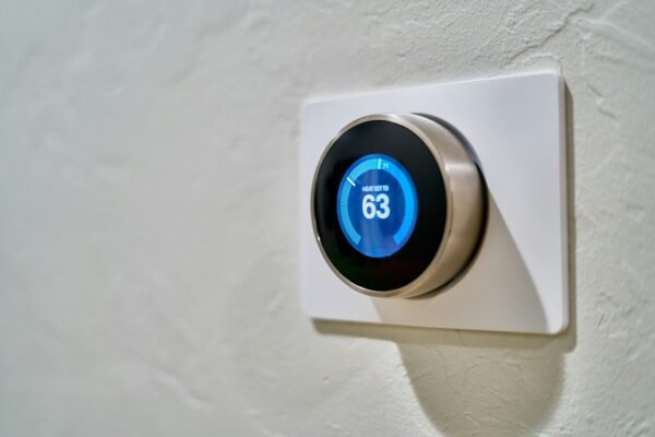Gray smart thermostat displaying temperature representing smart home devices