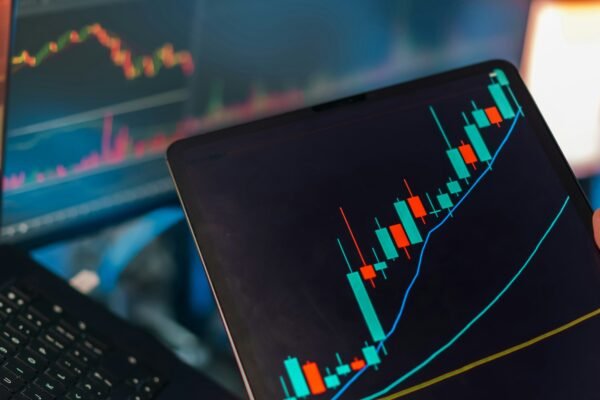 Trading charts displayed on multiple screens representing investment diversification