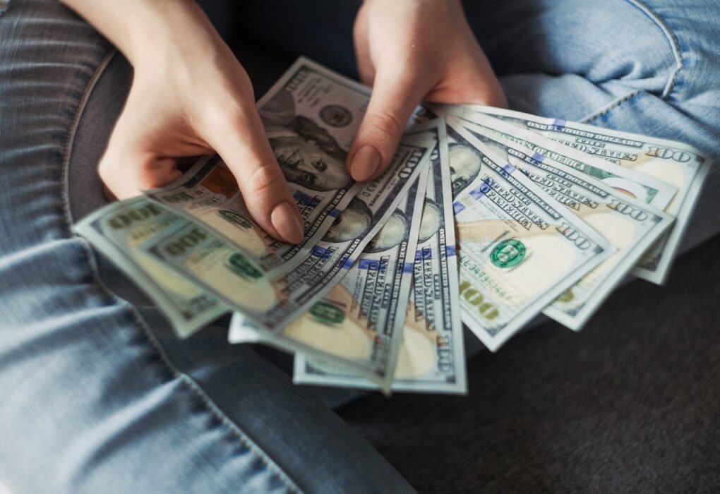 Fan of 100 dollar banknotes representing wealth building