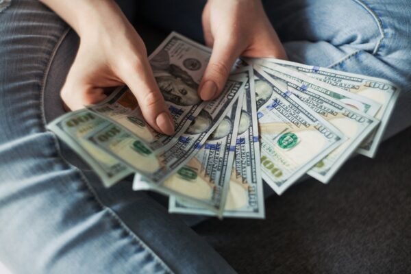 Fan of 100 dollar banknotes representing wealth building